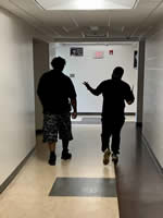 Two Detention Home Aides walking in a hallway at Hillbrook