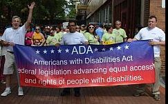 3 Marchers Hold ADA Banner at Start of Parade