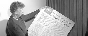Mrs. Eleanor Roosevelt of the United States holding a Universal Declaration of Human Rights poster in English.
